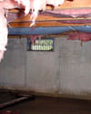 Pennsylvania crawl space with vents, showing mold, rot, and fiberglass insulation dripping off the ceiling.