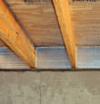 SilverGlo™ insulation installed in a floor joist in Brookville