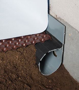 Closeup of a crawl space drainage system installed in Julian