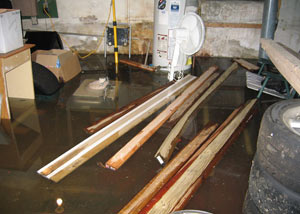 A severely flooding basement in Brockway, with lumber and personal items floating in a foot of water