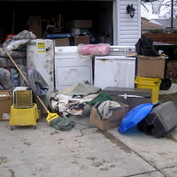 Soaked, wet personal items sitting in a driveway, including a washer and dryer in Port Matilda.