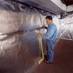 Installation of a radiant heat and vapor barrier on a basement wall in Johnsonburg