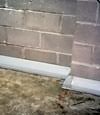 Our baseboard drain system installed on a corner in a Brockway basement.