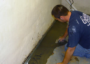 Restoring a concrete slab floor with fresh concrete after jackhammering it and installing a drain system in Bellwood.