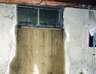 Water pouring out from a basement window in Saint Marys